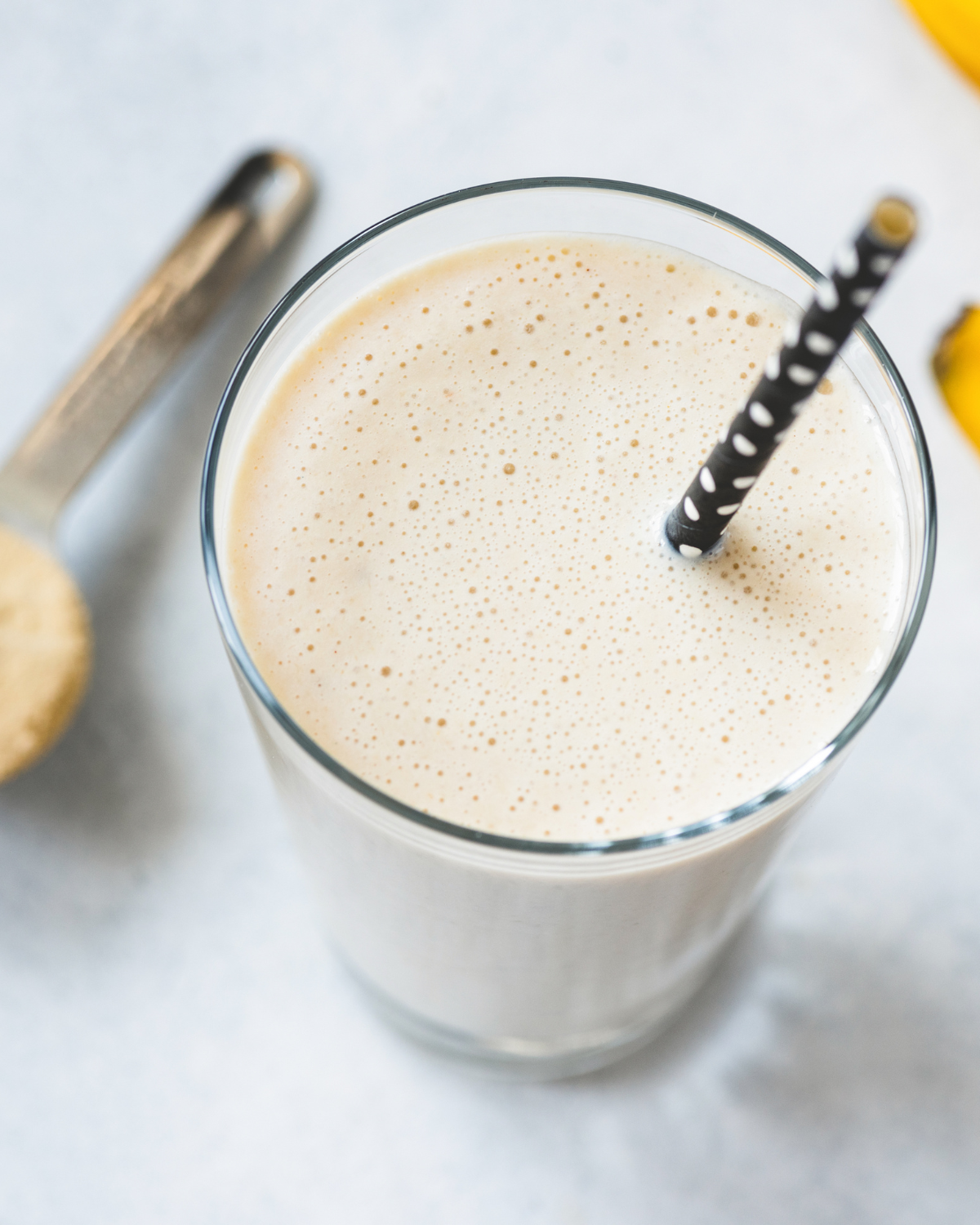 Protein shake vs smoothie comparison - glass of chocolate protein shake with shaker bottle