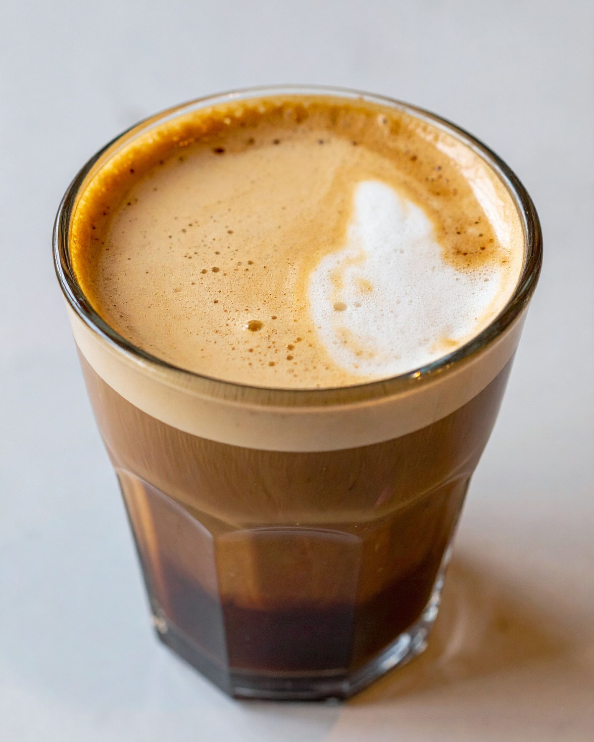 macchiato vs latte – traditional espresso macchiato with milk foam dollop in small cup